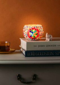 Lit Turkish candle holder on console table