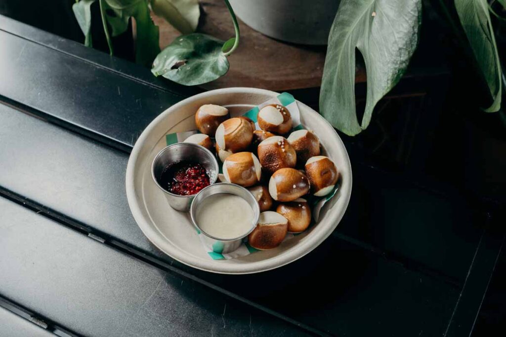 Delicious-looking pretzels and dipping sauces on a plate